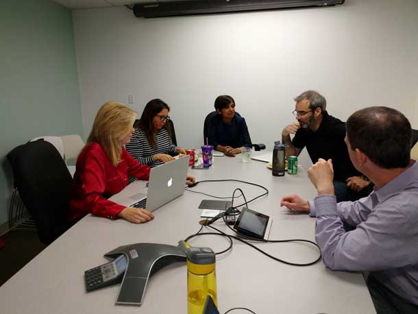 Five people around a conference table.