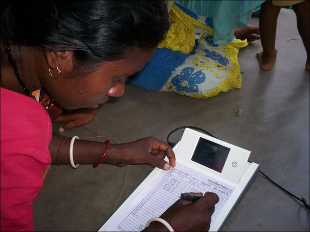 Woman writes on large tablet prototype.