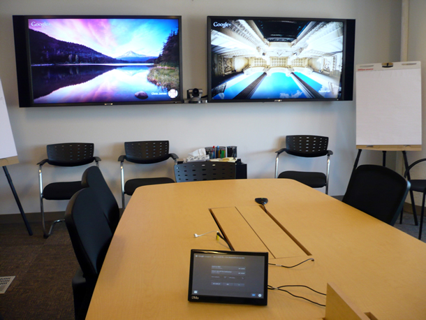 A room with a two-screen teleconferencing system