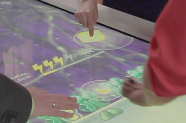 Closeup of hands playing on the interactive surface