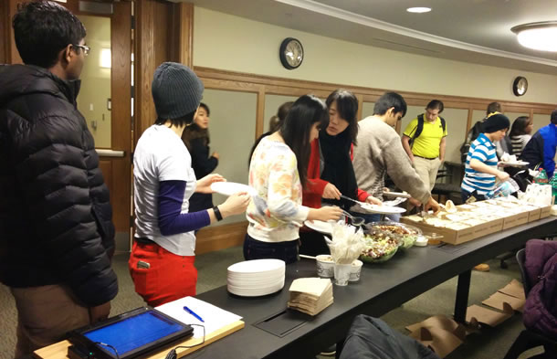 Students line up at a food buffet.