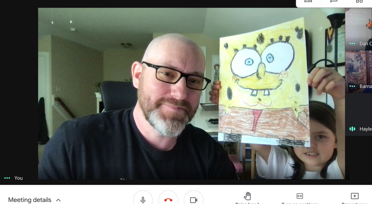 Screenshot of a video software showing the author and his child displaying her hand-colored art of Sponge Bob.