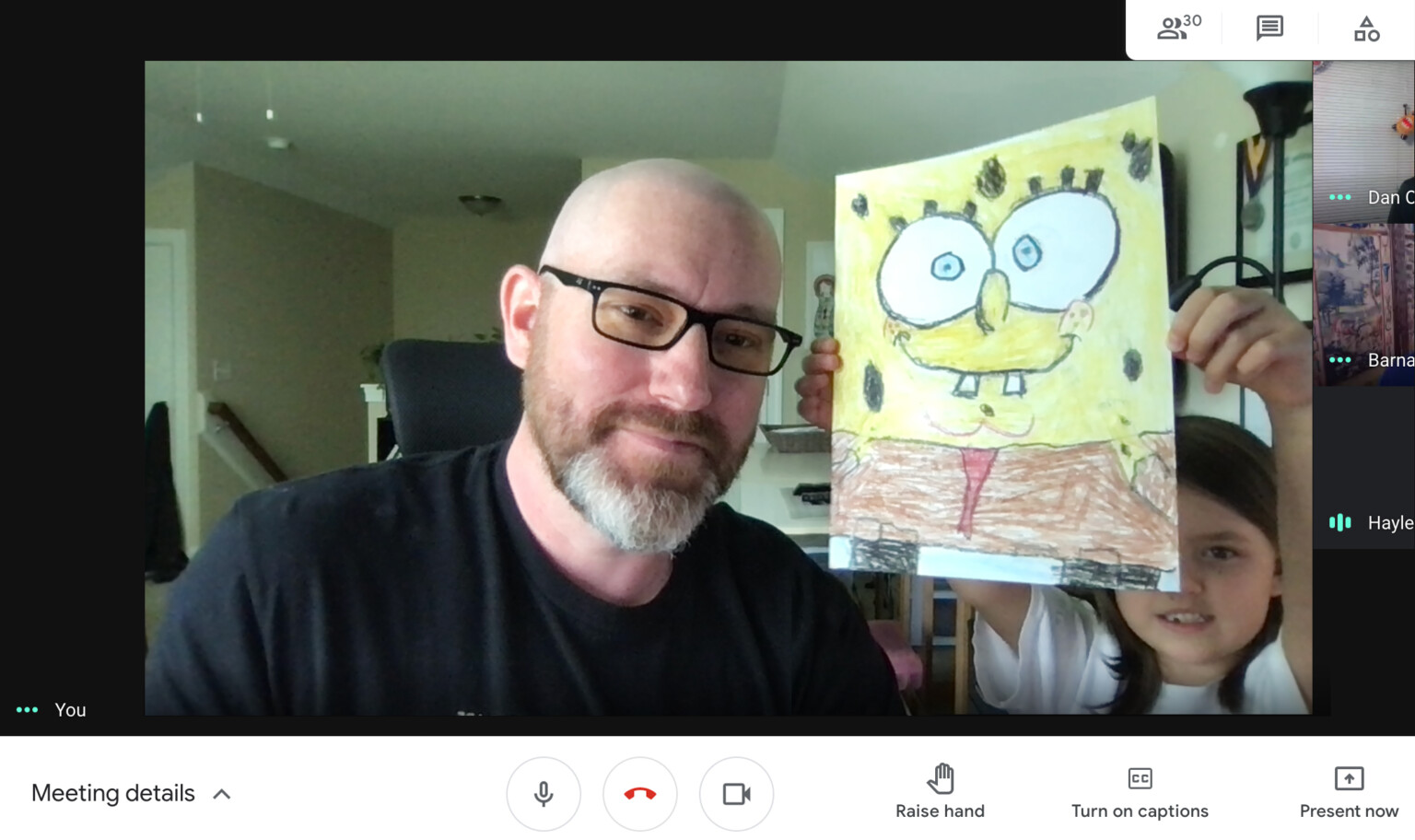 Screenshot of a video software showing the author and his child displaying her hand-colored art of Sponge Bob.